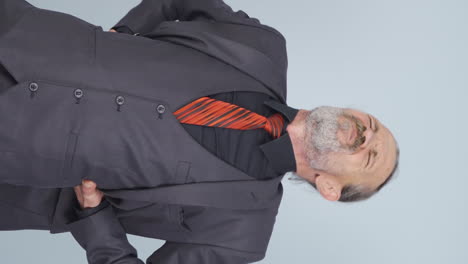 Vertical-video-of-Old-businessman-experiencing-back-pain.
